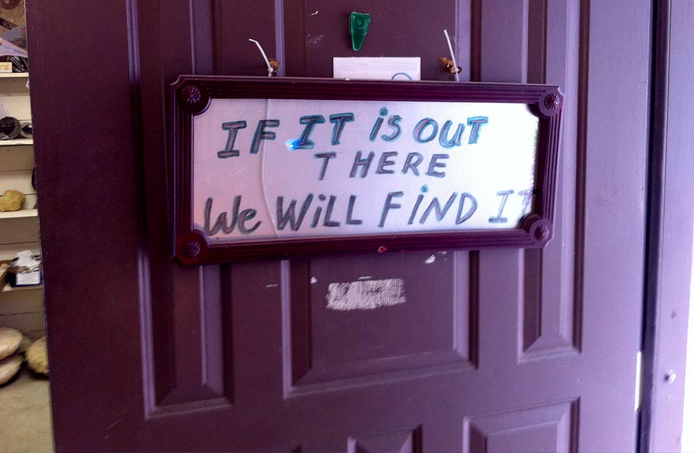 a sign that says "if it is out there we will find it" on a door