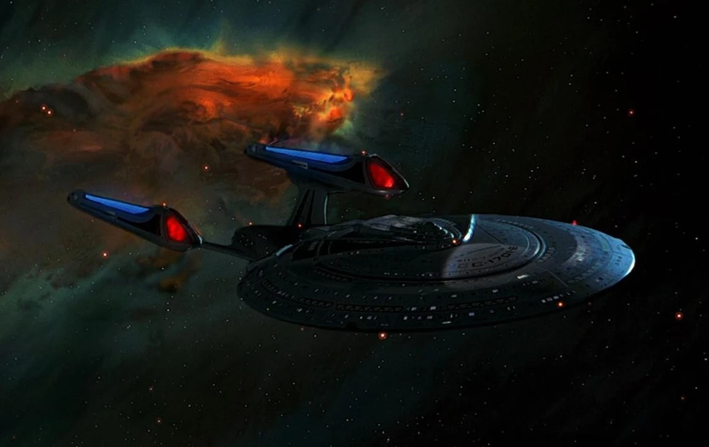 the uss enterprise flying past a nebula in space