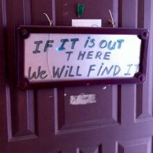 a sign that says "if it is out there we will find it" on a door